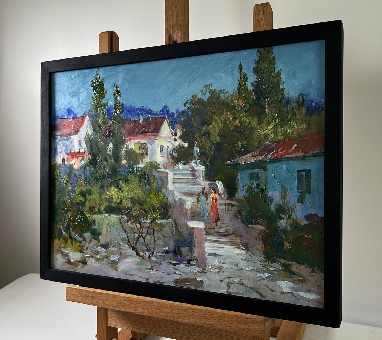 Framed oil painting of city streets walk by Yuriy Suprunchuk with vibrant colors