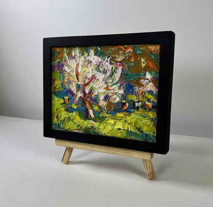 Oil painting Petals dancing in spring breeze by Oksana Ivanyuk in black frame