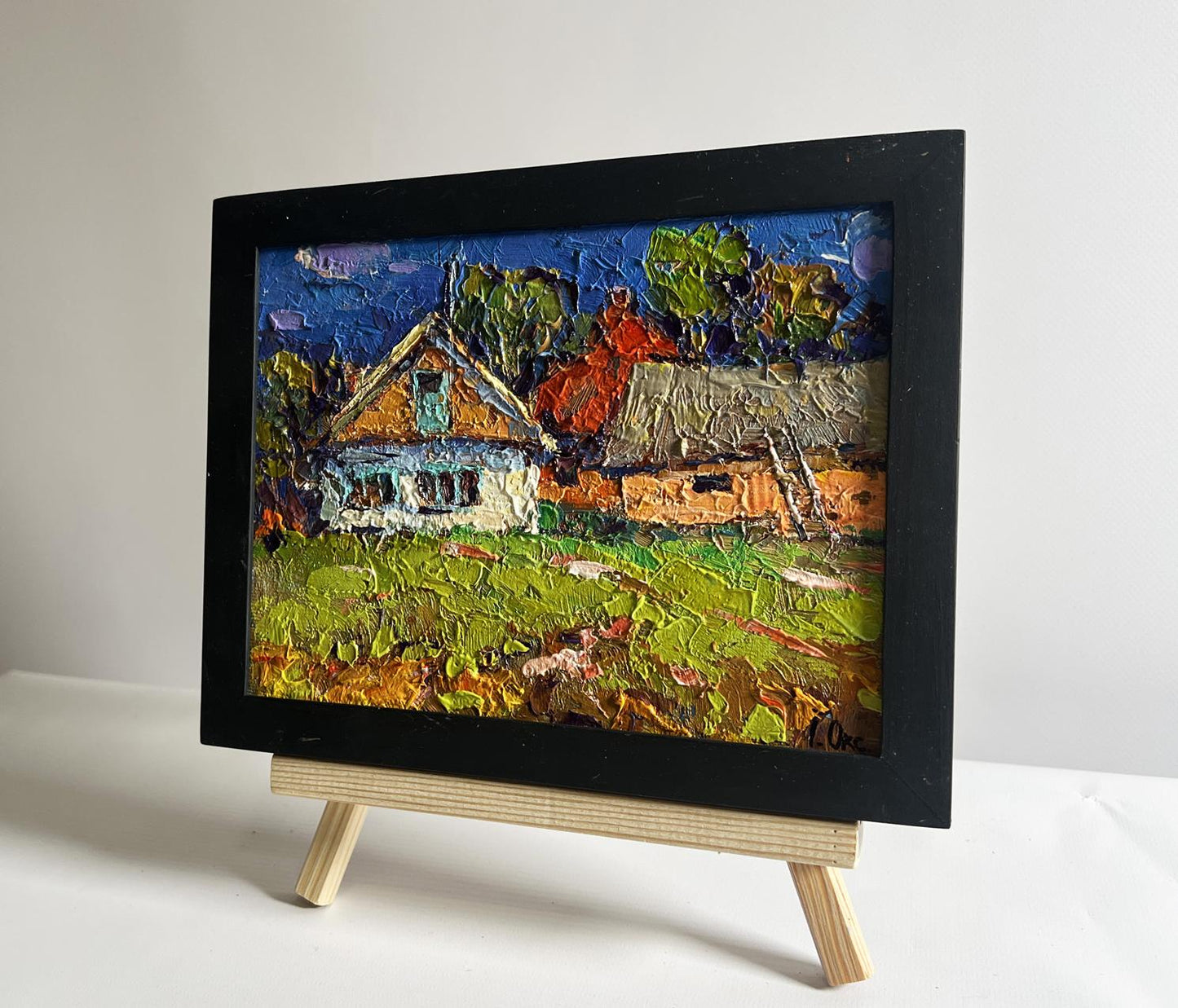 Vibrant oil painting Sunny day in the village by Oksana Ivanyuk in black frame