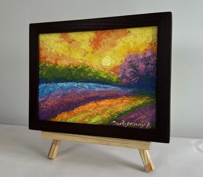 Vibrant oil painting of sunset over blooming purple orange fields by V. Zadorozhnya in dark frame