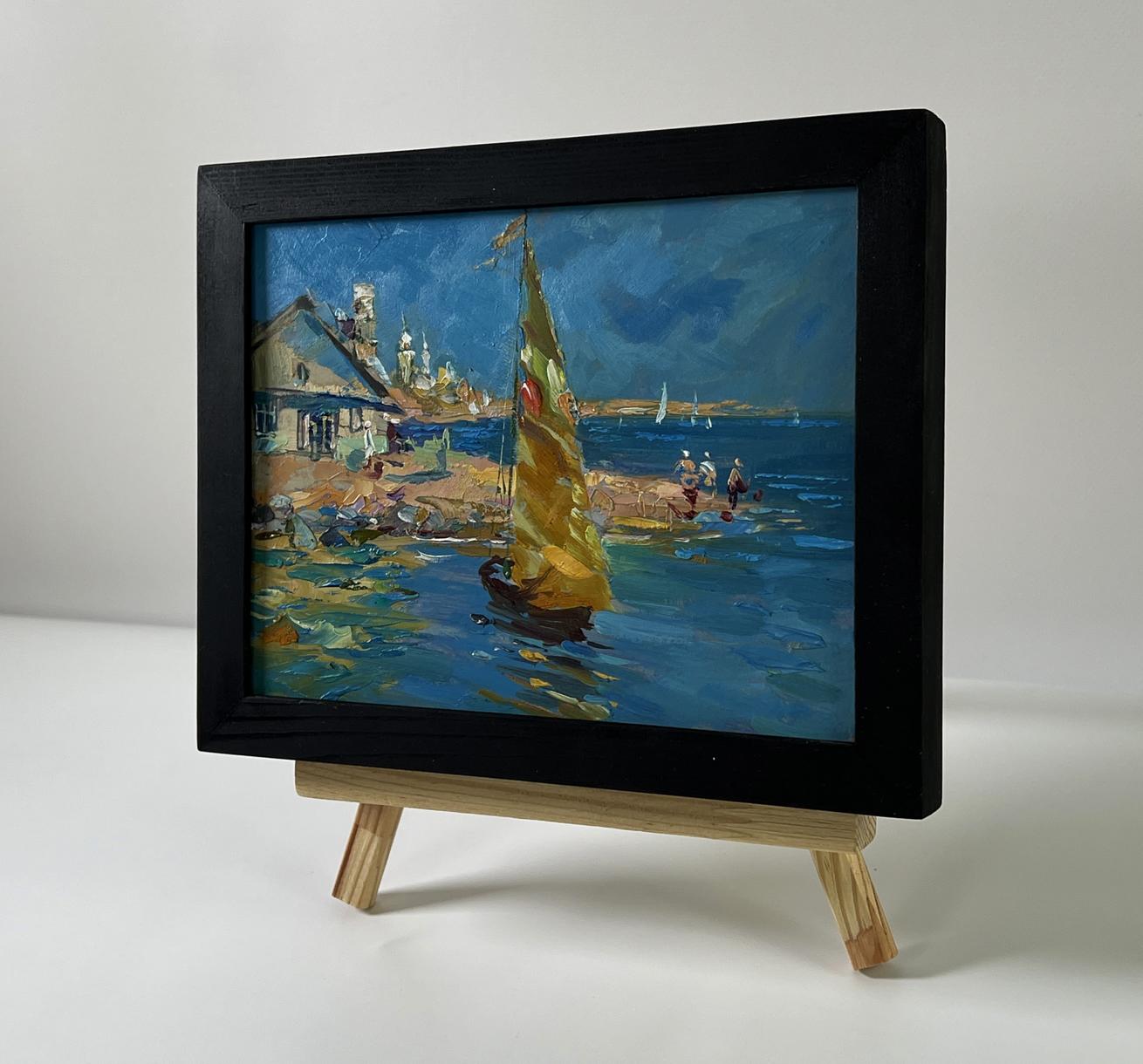 Framed oil painting of sailboat and house on seashore by Yuriy Suprunchuk