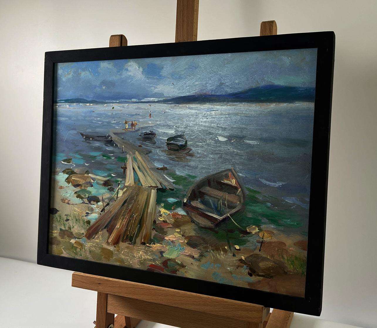 Framed oil painting of boats on river bank by Yuriy Suprunchuk