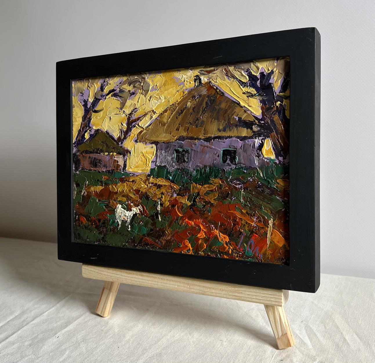 Black-framed oil painting by Oleksiy Ivanyuk: yellow sunset behind rustic village houses