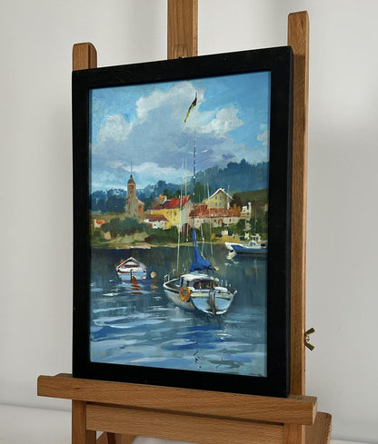 Framed oil painting of boats off city coast by Yuriy Suprunchuk