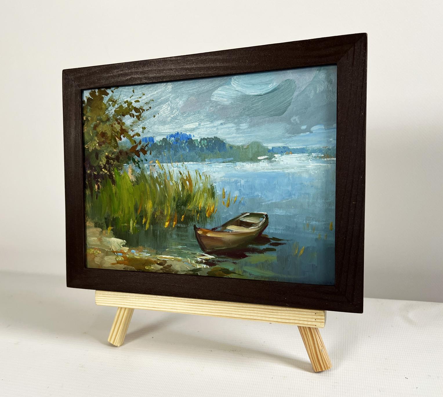 Oil painting of boat among reeds by Yuriy Suprunchuk in wood frame