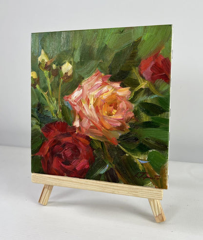 Oil painting Summer Roses in the Garden by Vyacheslav Pereta on easel