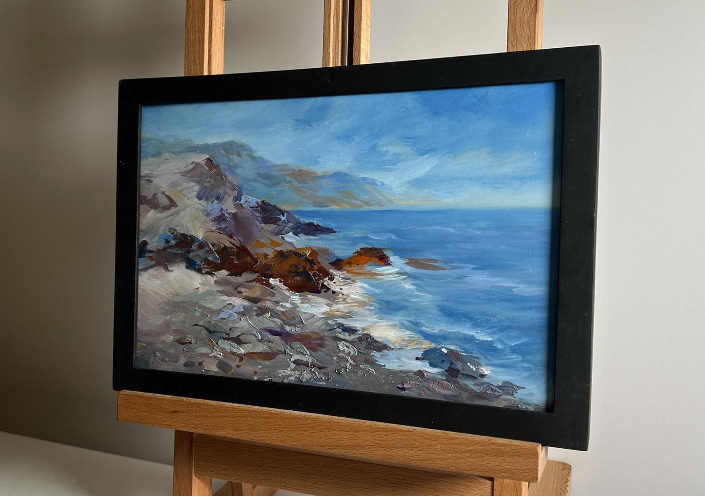 Framed oil painting by Yuriy Suprunchuk of sea waves beating shore