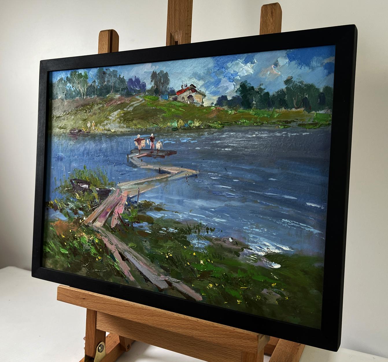 Black-framed oil painting by Yuriy Suprunchuk of riverside dock scene