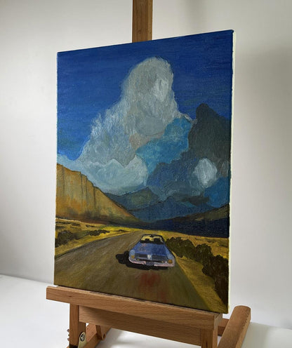 Oil painting Journey to the Mountains: silver car on desert road under blue skies