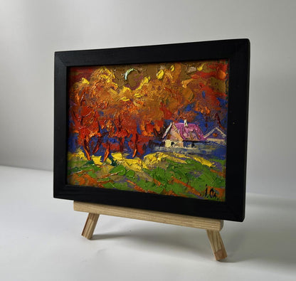 Oil painting by Oleksiy Ivanyuk: autumn trees in fiery orange leaves