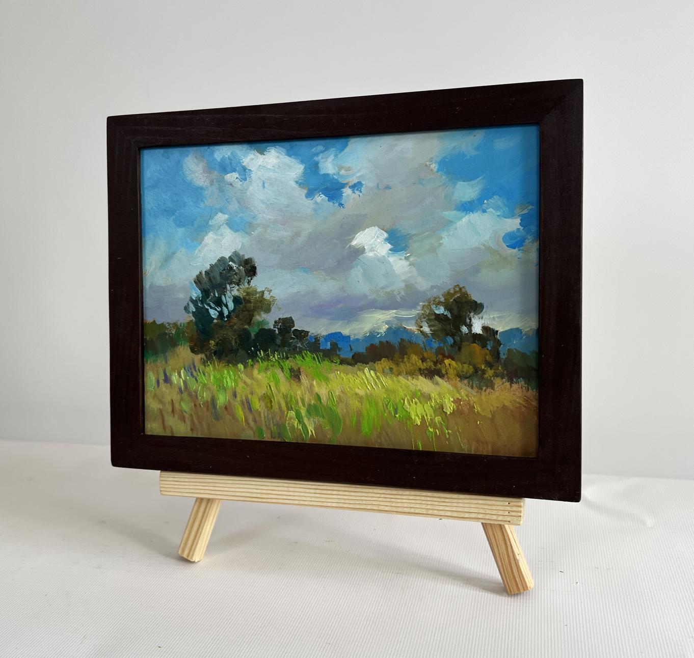 Oil painting of summer meadow glade by Yuriy Suprunchuk in wooden frame on easel