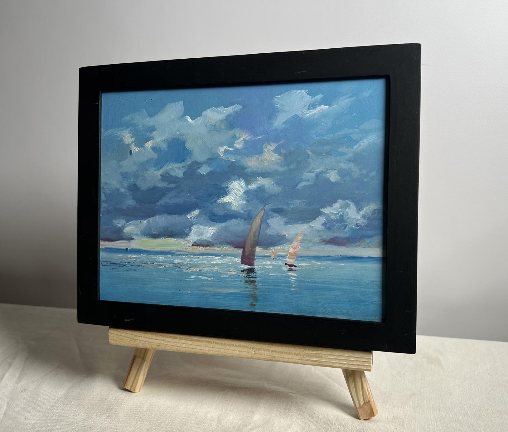 Black-framed oil painting of sailboats on blue sea by Yuriy Suprunchuk