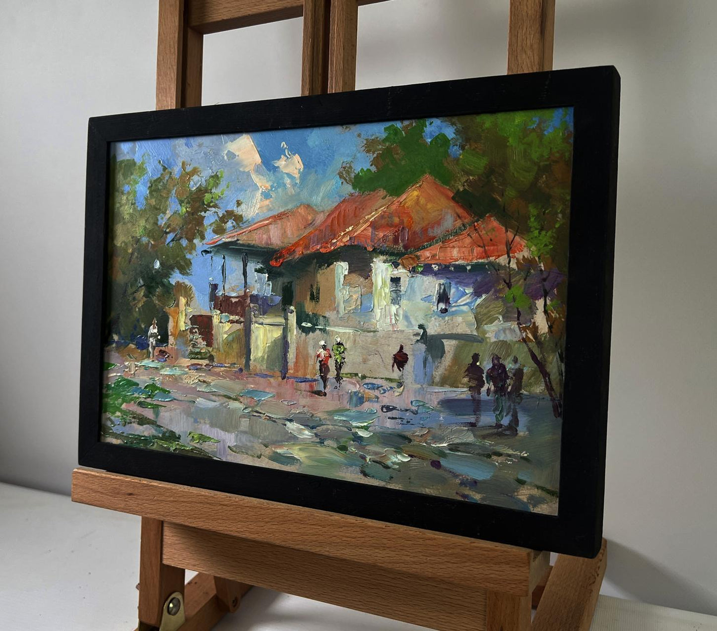Oil painting of city buildings by Yuriy Suprunchuk, vibrant street scene