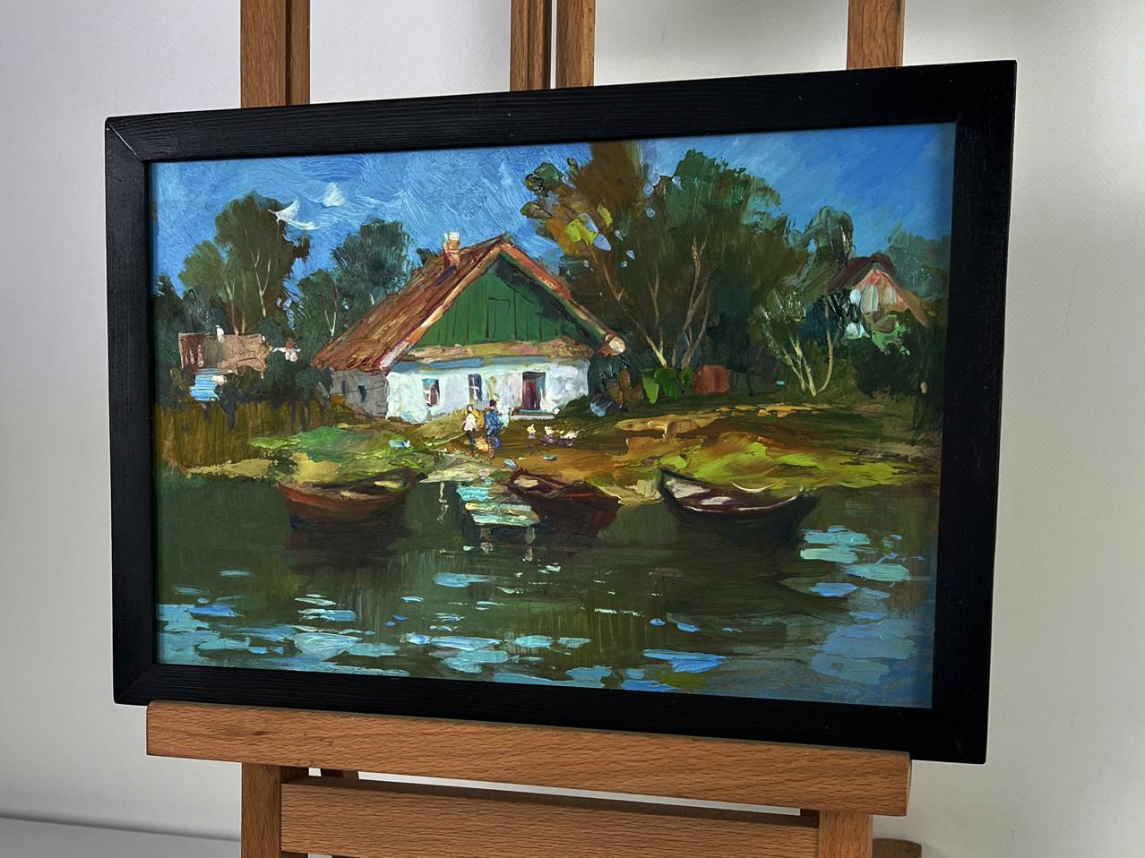 Oil painting by Yuriy Suprunchuk: rustic village with green-roofed houses, boats