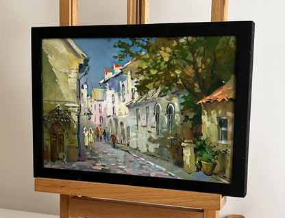 Framed oil painting of sunlit cobblestone street by Yuriy Suprunchuk