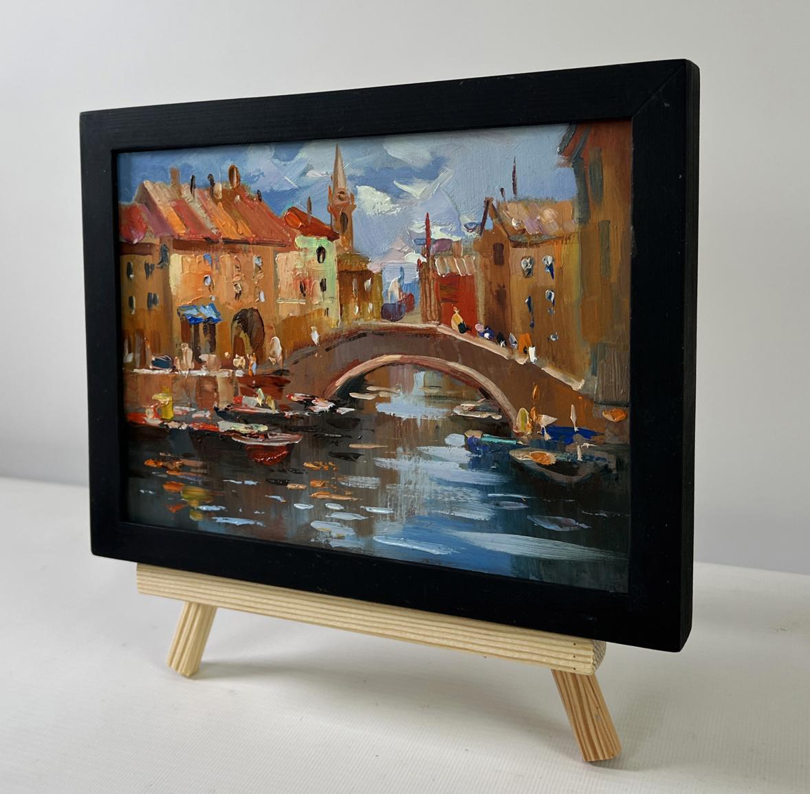 Framed Oil painting City Central Bridge by Yuriy Suprunchuk on easel
