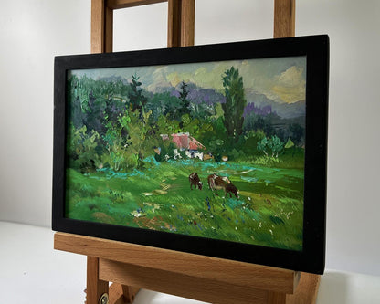 Framed oil painting by Yuriy Suprunchuk of pastoral cows in lush fields