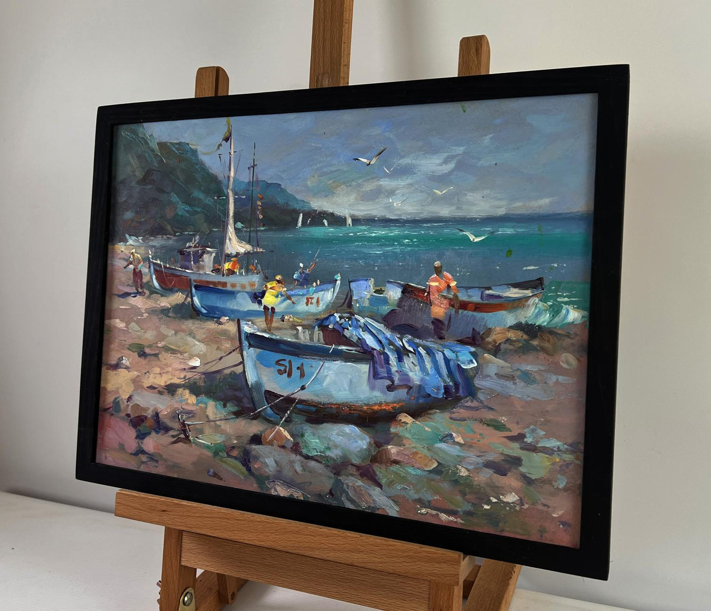 Framed oil painting of fishermen boats on rocky coast by Yuri Suprunchuk