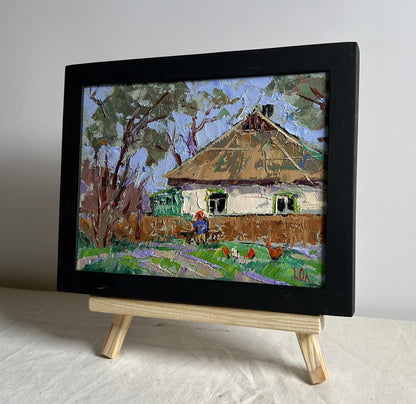 Rustic oil painting of thatched cottage with grandma on bench by Oleksiy Ivanyuk