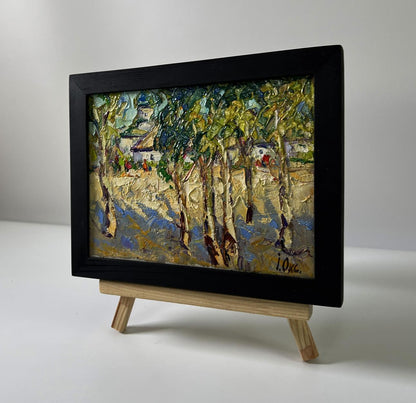 Oil painting Summer day in the village by Oksana Ivanyuk in black frame on easel