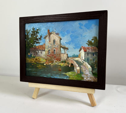 Dark wooden-framed oil painting of Yuriy Suprunchuk bridge to city