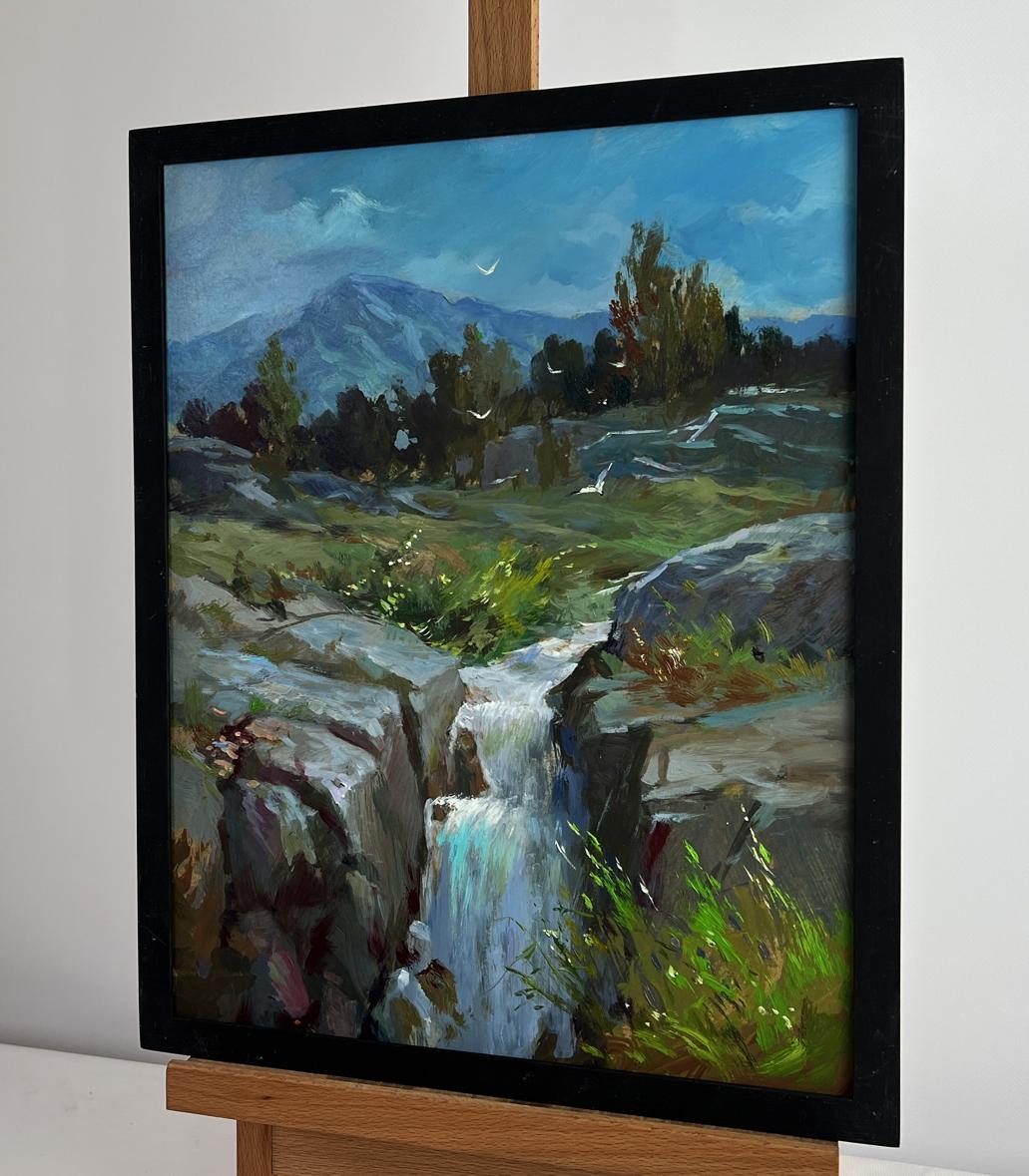 Oil painting of mountain waterfall by Yuriy Suprunchuk in black frame on easel