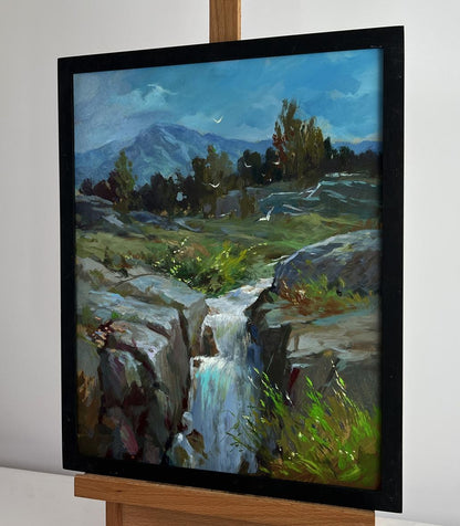 Oil painting of mountain waterfall by Yuriy Suprunchuk in black frame on easel