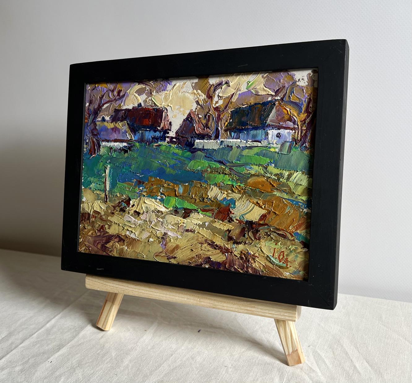 Vibrant oil painting of sunset behind houses by Oleksiy Ivanyuk in black frame