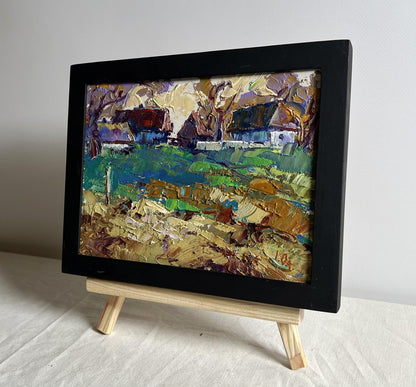 Vibrant oil painting of sunset behind houses by Oleksiy Ivanyuk in black frame