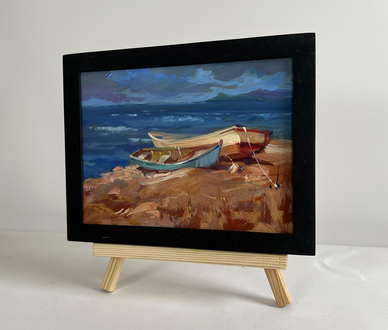 Oil painting Calm evening sea by Yuriy Suprunchuk: boats on rocky shore under stormy sky
