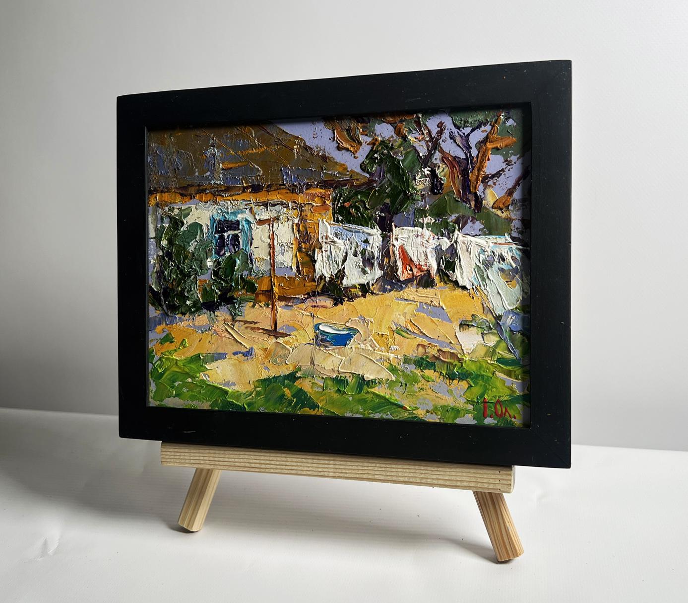 Oil painting by Oleksiy Ivanyuk: laundry drying in yard with trees
