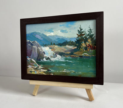Oil painting of waterfall in mountains by Yuriy Suprunchuk in dark frame