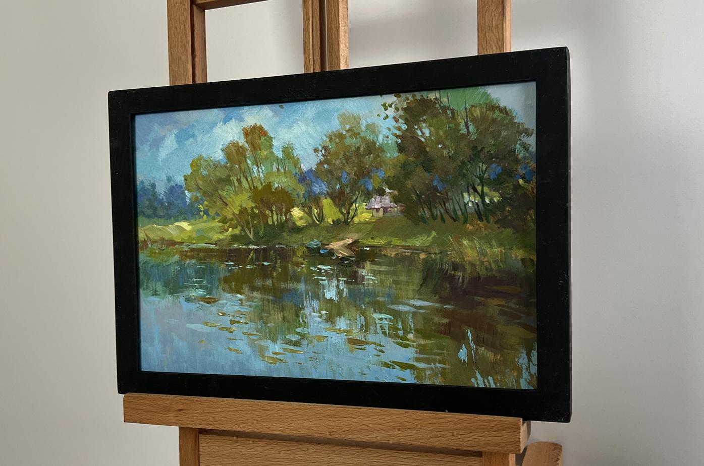 Oil painting of quiet ferryman in village by Yuriy Suprunchuk in black frame