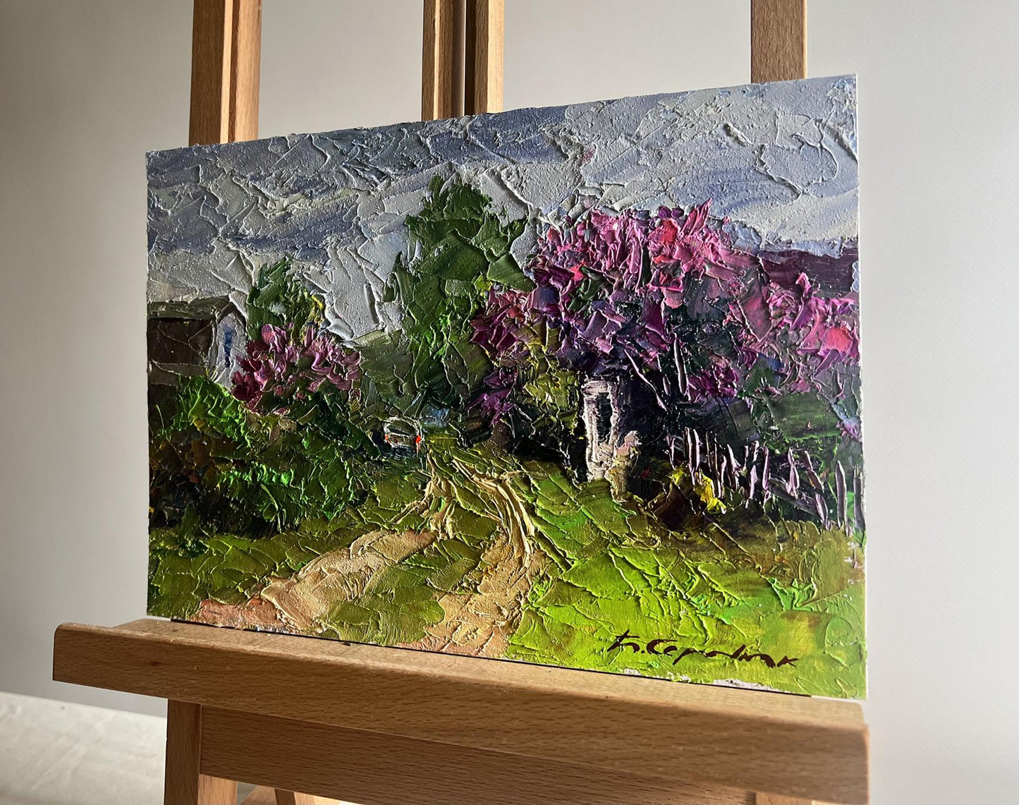 Oil painting Lilac growing in the village by Boris Serdyuk on easel