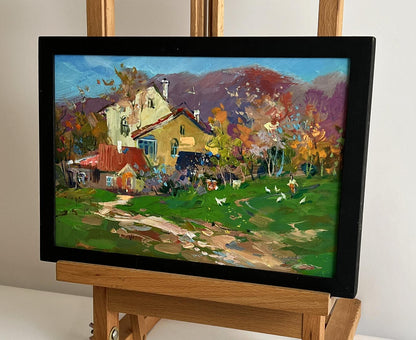 Vibrant impressionist oil painting of autumn rural scene with houses by Yuriy Suprunchuk, black frame