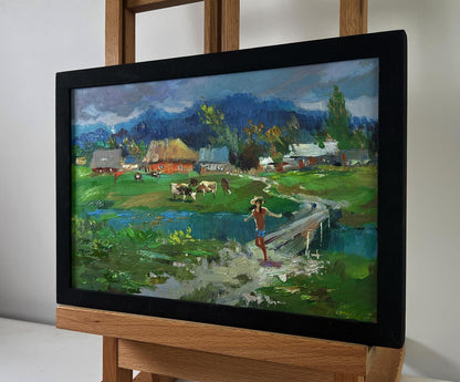 Oil painting by Yuriy Suprunchuk: cows grazing by river, village bridge scene
