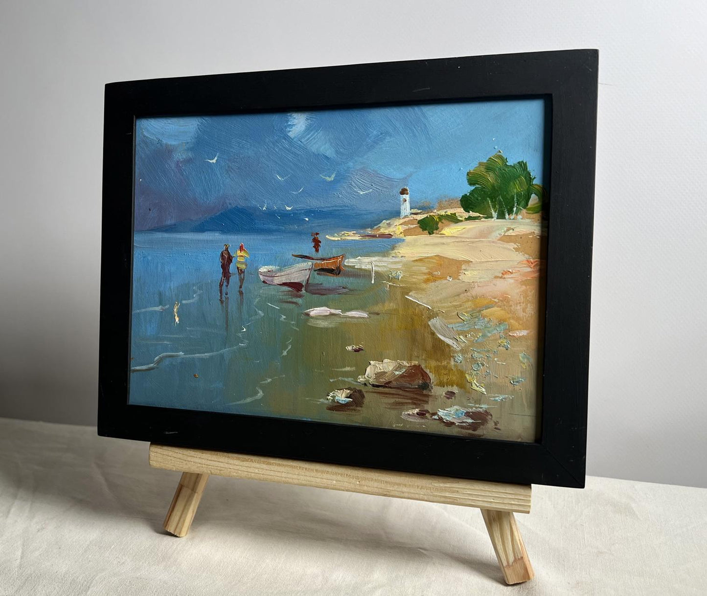 Black-framed oil painting Warm days at sea by Yuriy Suprunchuk