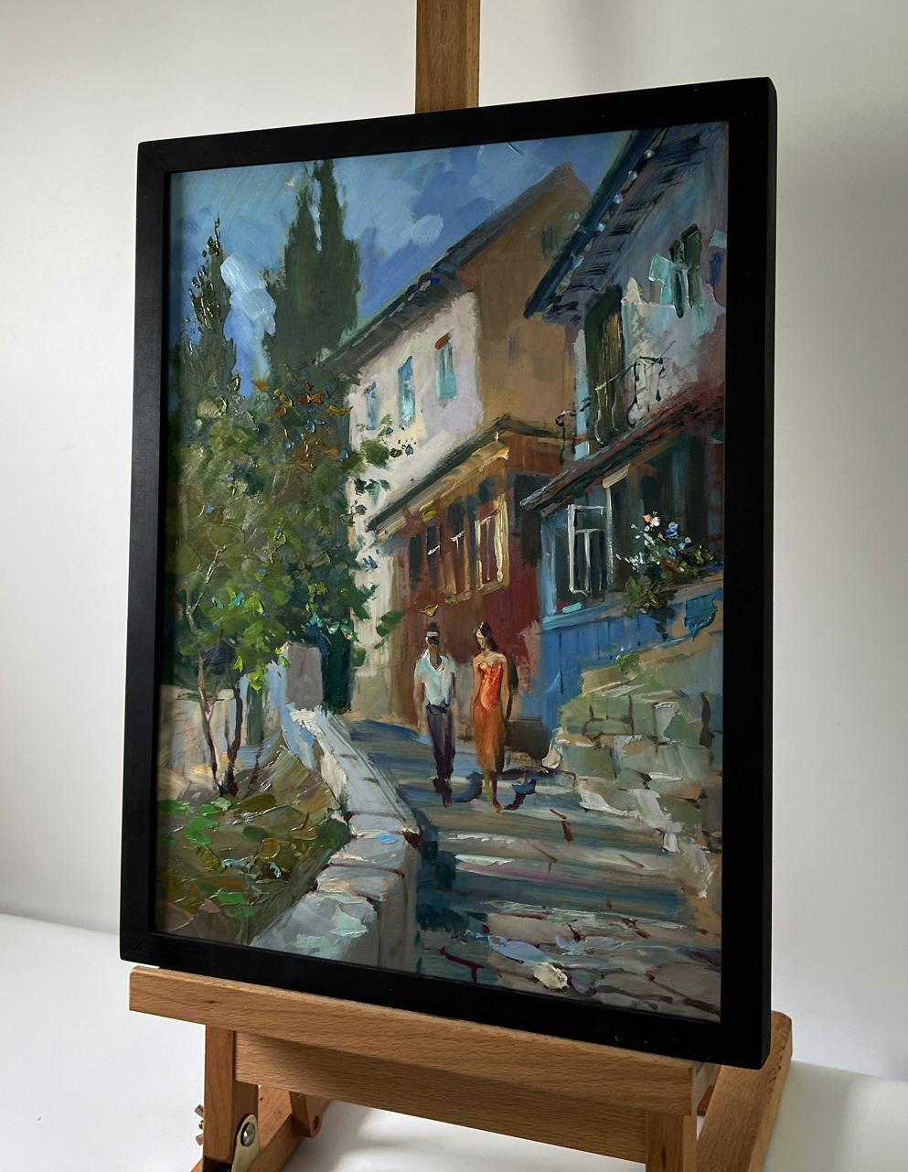 Framed oil painting by Yuriy Suprunchuk of couple on sunlit cobblestone street