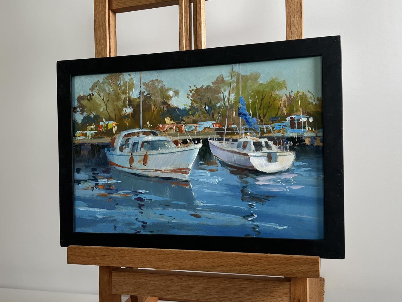 Framed impressionistic oil painting of white boats in harbor by Yuriy Suprunchuk