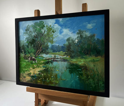 Framed oil painting of serene landscape with bridge over river by Yuriy Suprunchuk