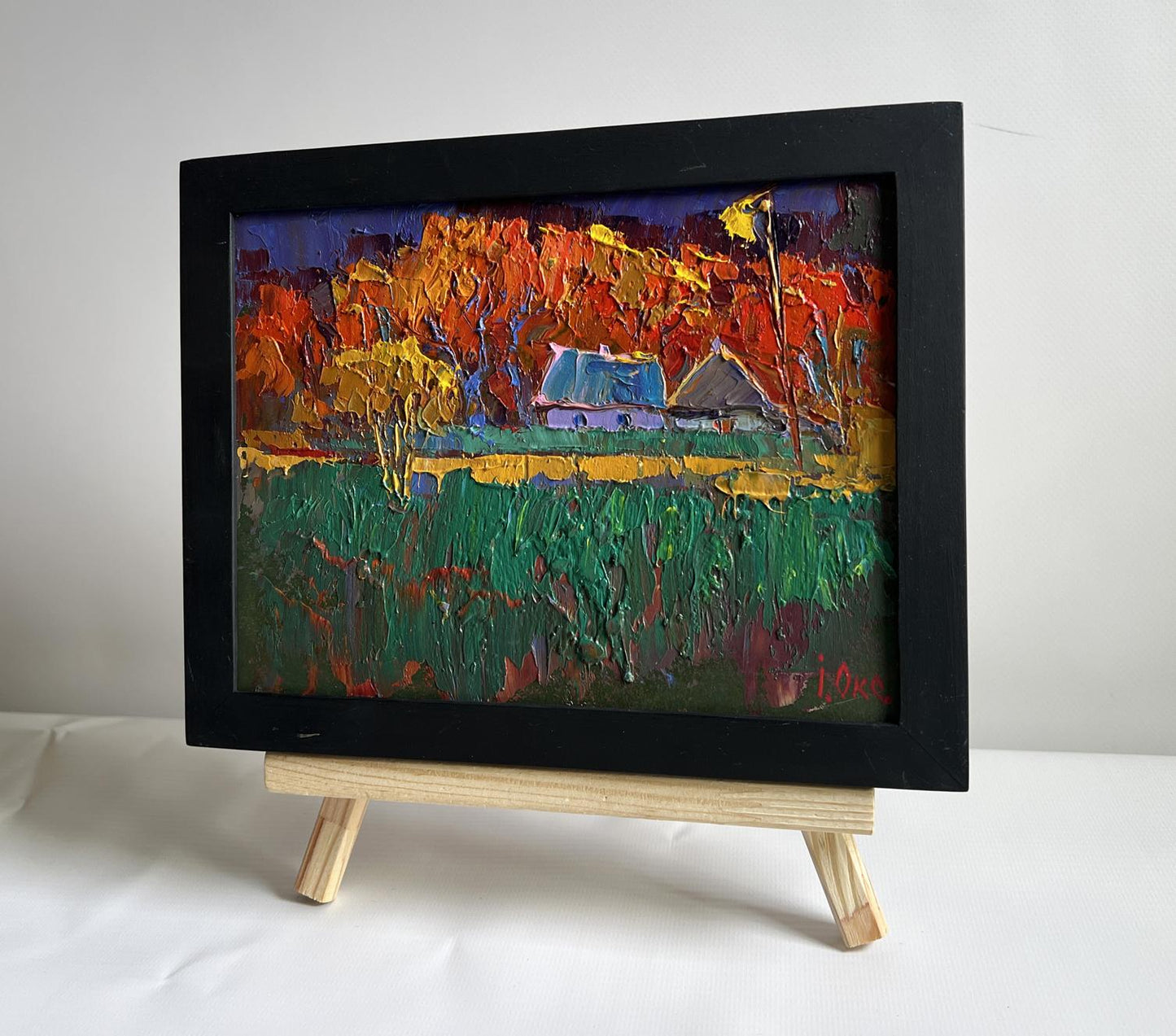 Oil painting Crimson Autumn in the Village by Oksana Ivanyuk in black frame