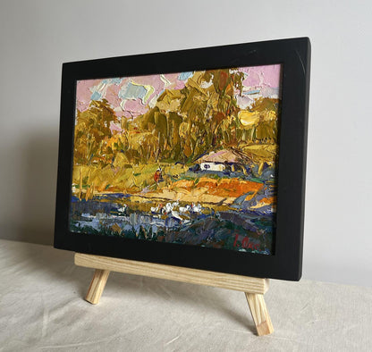 Oil painting of splashing ducklings by Oksana Ivanyuk in black frame