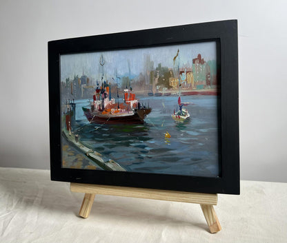 Black-framed oil painting of ship at pier by Yuriy Suprunchuk
