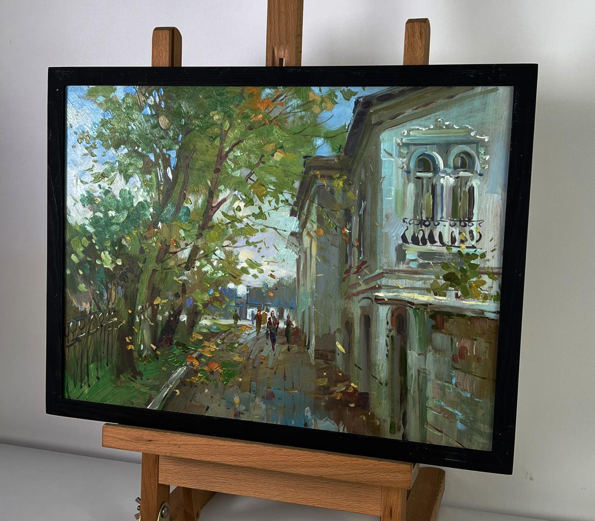 Framed oil painting of sunlit city street by Yuriy Suprunchuk