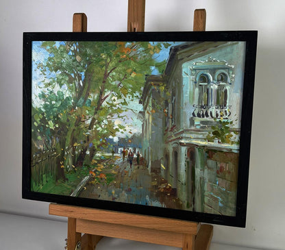 Framed oil painting of sunlit city street by Yuriy Suprunchuk