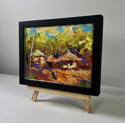 Oil painting by Oleksiy Ivanyuk: warm evening sunset over colorful village