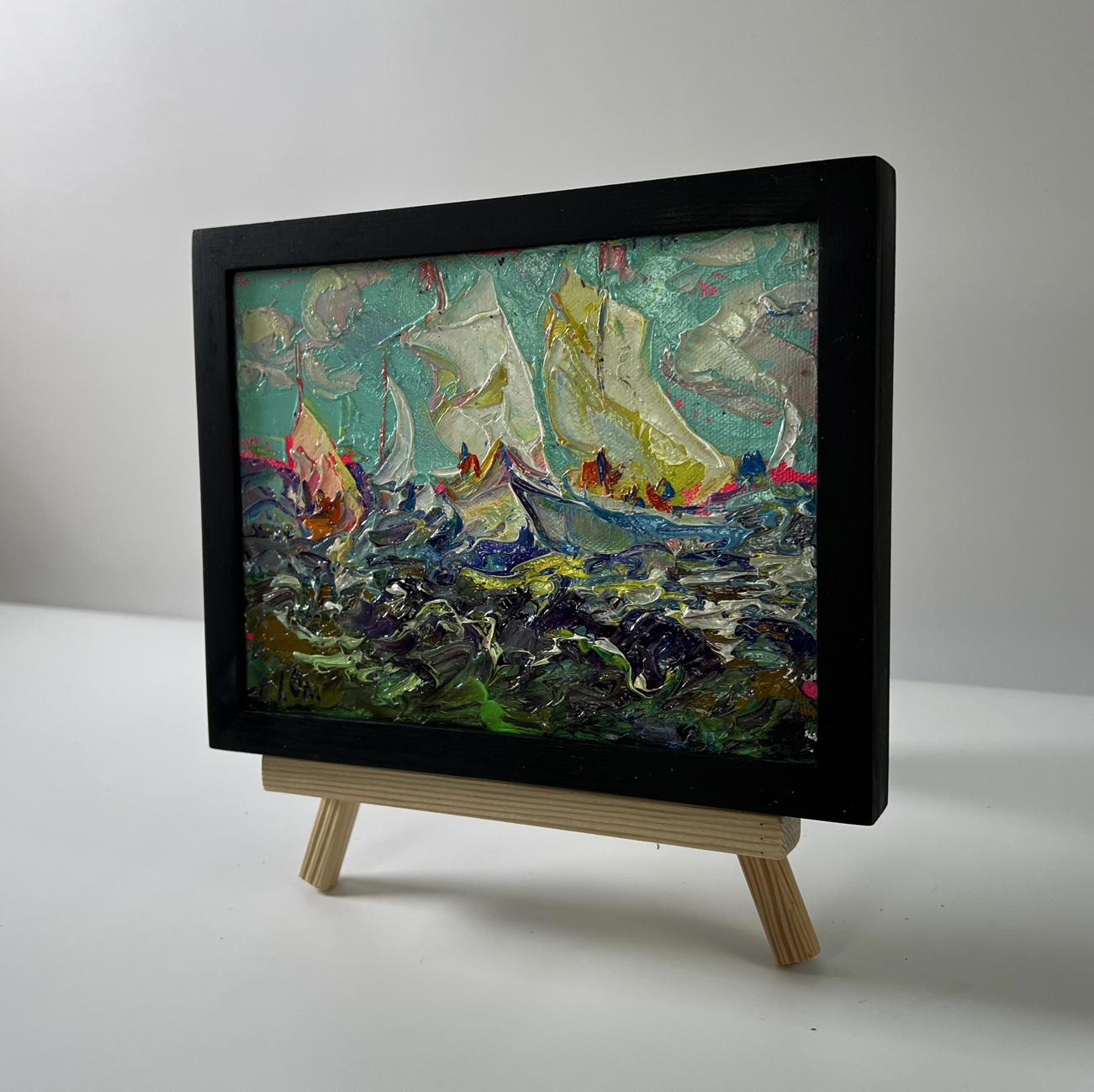 Oil painting Sailboats on the sea by Oleksiy Ivanyuk in black frame on easel