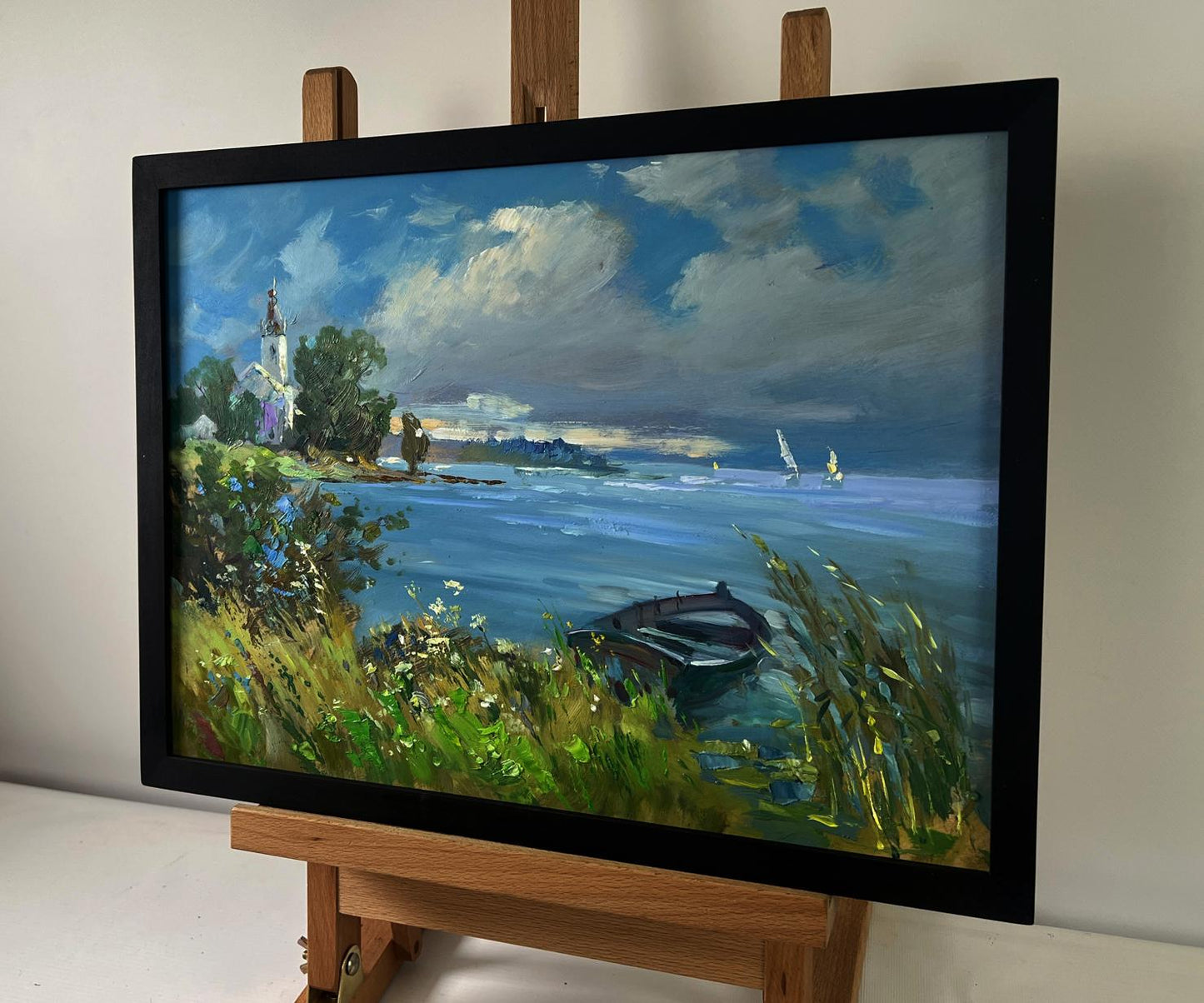 Framed oil painting of lonely boat on lakeside by Yuriy Suprunchuk