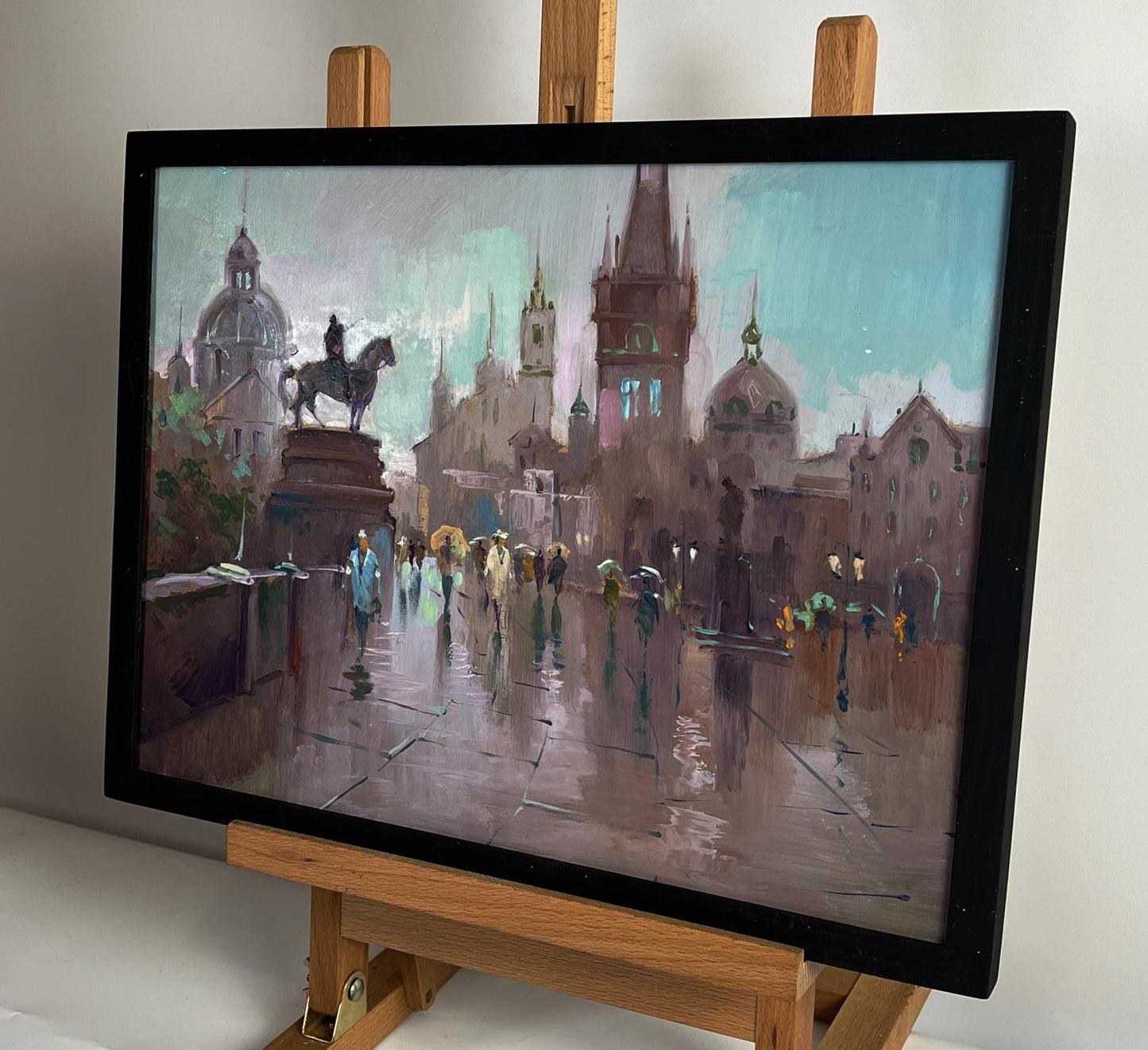 Oil painting of Yuriy Suprunyuks rainy city central square in black frame