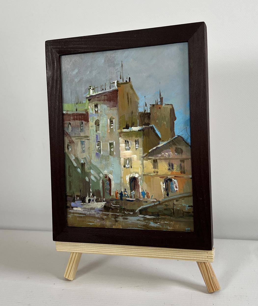 Framed oil painting of city street shadows by Yuriy Suprunchuk on easel